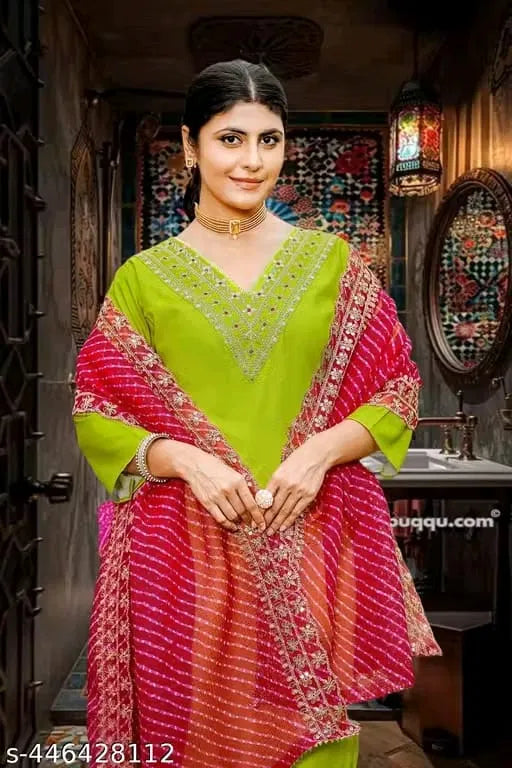 Woman in premium lime green ethnic kurta with embellished neckline and pink dupatta
