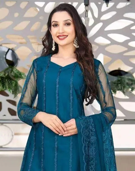 Woman wearing premium teal rayon kurti set with sheer embroidered sleeves and ethnic design