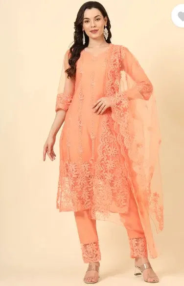 Woman wearing premium peach embroidered ethnic suit with sheer dupatta, showcasing fine fabric and intricate floral design.