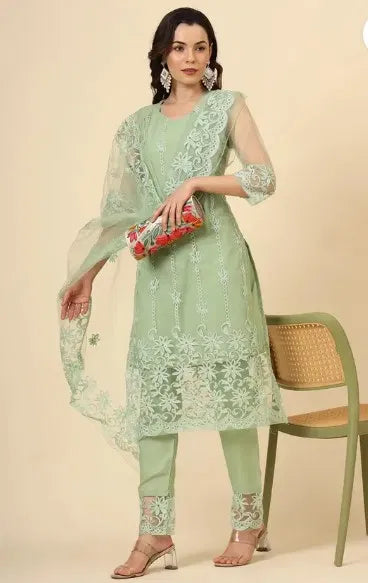 Woman in pastel green embroidered ethnic suit with sheer dupatta, premium fabric