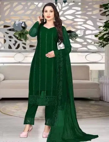 Woman wearing a premium dark green rayon kurti set with elegant ethnic embroidery detail.