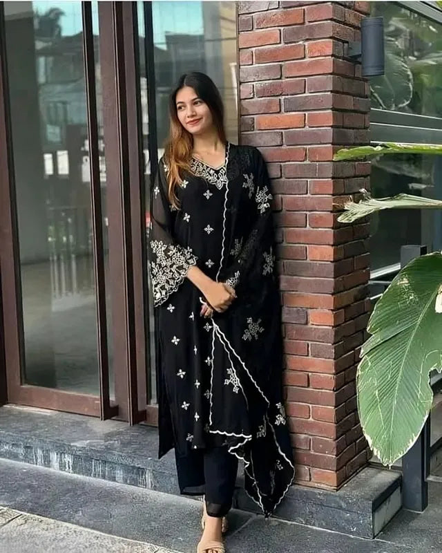 Woman wearing premium black rayon kurti set with white ethnic embroidery designs